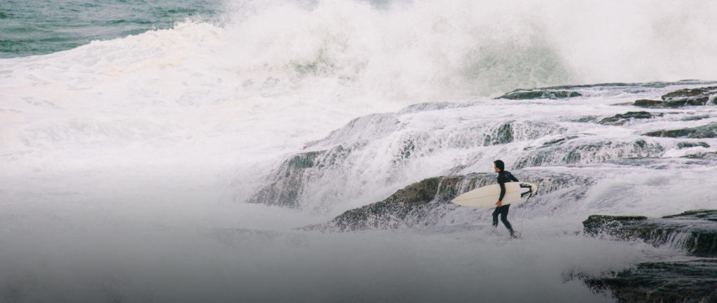 surfer on the rocks