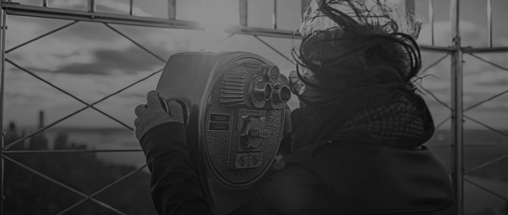 woman looking through magnifying glasses