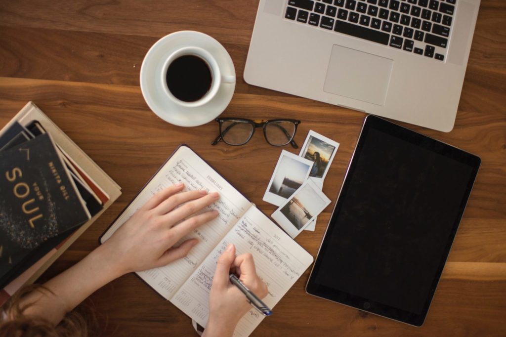 person writing in notebook